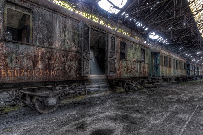 Abandoned rusty train in a derelict train shed