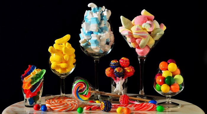 Assortment of colorful candies and marshmallows in glasses