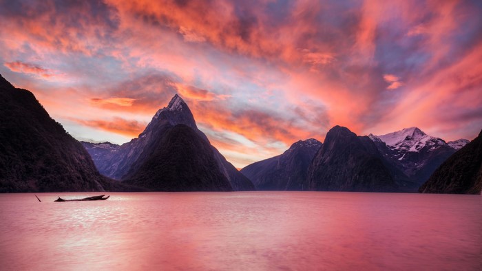 4K Sunset Over Mountains and Water with Boat