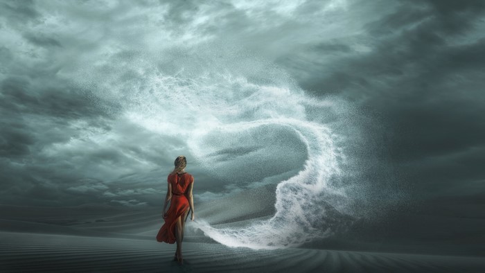 Woman in red dress in a sandstorm