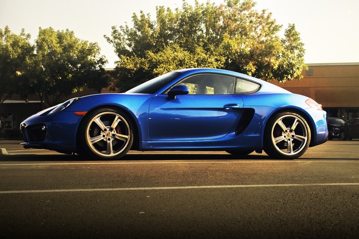 Blue Porsche Cayman in a parking lot