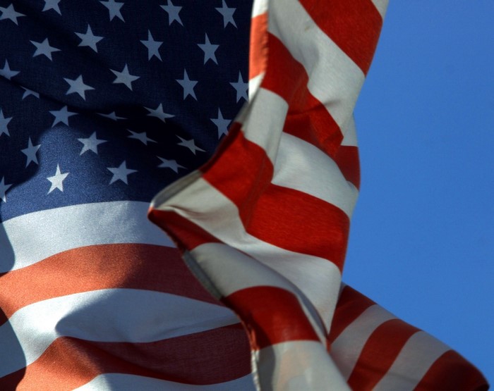 American Flag Waving Against Blue Sky