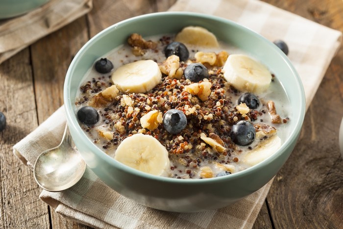 Bowl of quinoa cereal with blueberries, bananas, and walnuts
