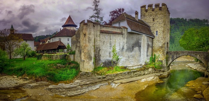 Old castle building in Switzerland by a river