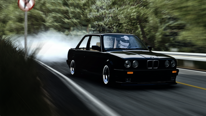Black BMW E30 M3 drifting on a road