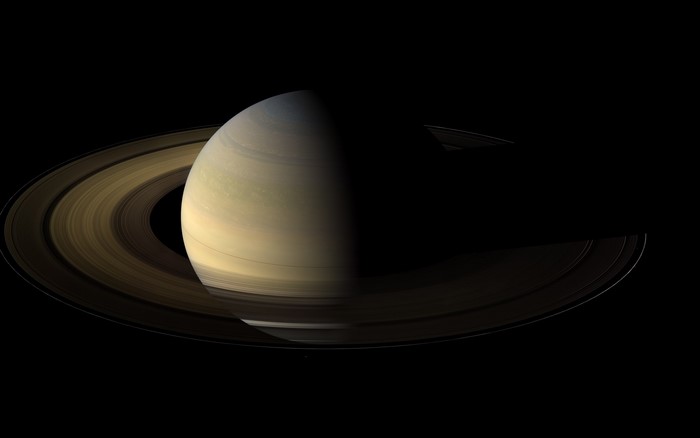 Saturn and its rings in space