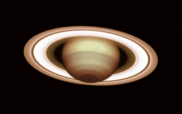 Saturn and its rings in space