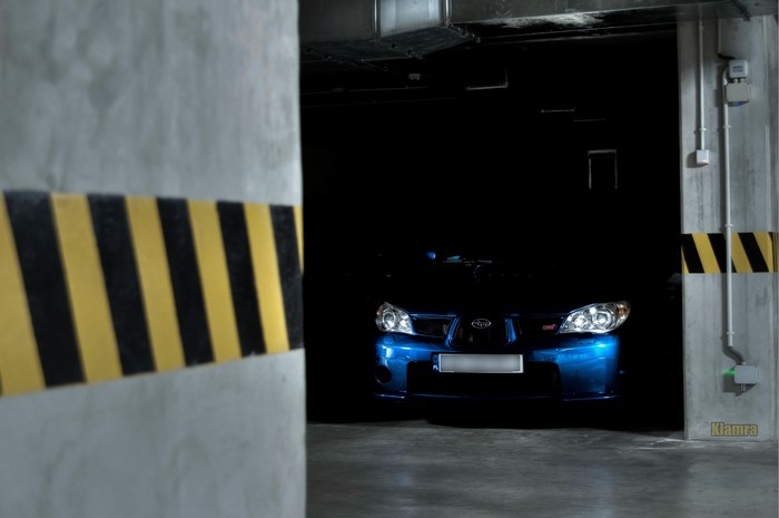 Blue Subaru Impreza WRX STi in a parking garage