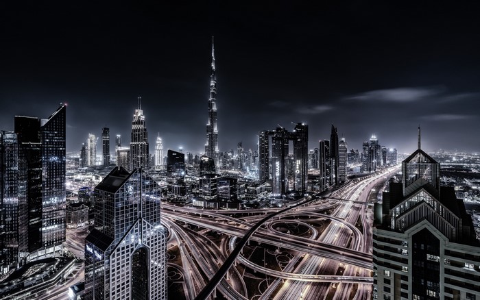 Dubai cityscape with skyscrapers and traffic at night