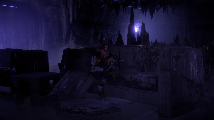 Aloy from Horizon Zero Dawn sitting in a cave