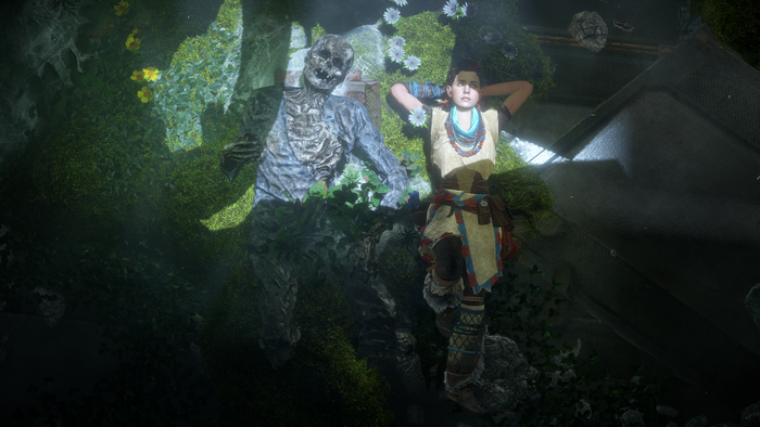 Aloy from Horizon Zero Dawn with a corpse in a cave
