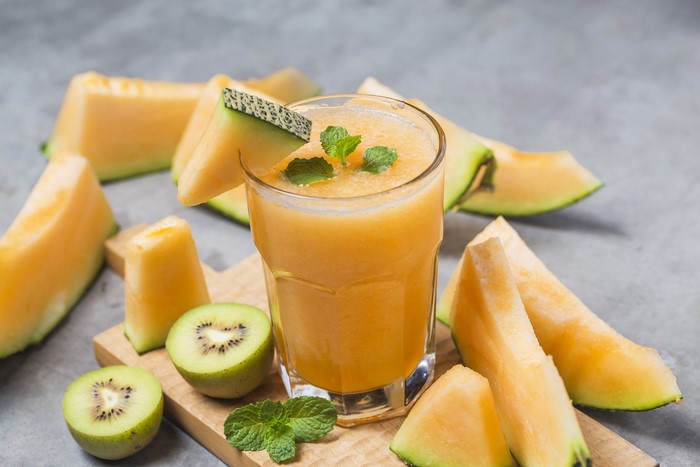 Melon and kiwi juice with mint and fruit slices