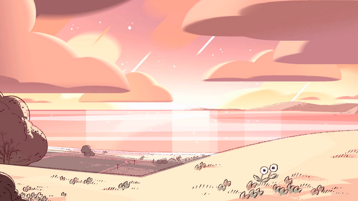 Pink sky over a calm ocean with clouds