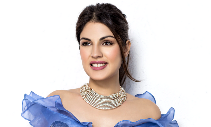 Rhea Chakraborty in a blue dress with a necklace