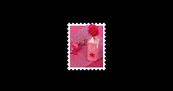 Fiji water bottle with pink rose and flower