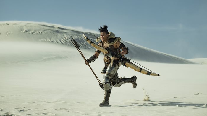 Tony Jaa in Monster Hunter running with bow and arrow