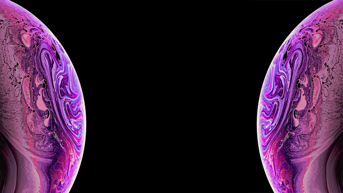 Abstract purple and pink planet-like shapes on black background