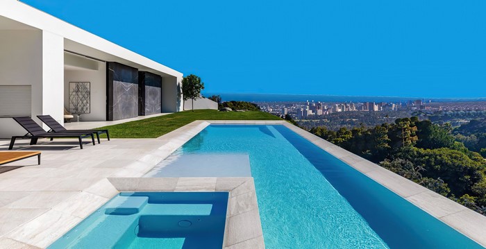Modern swimming pool with city skyline view
