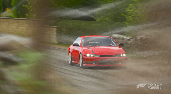 Red car driving through sprinklers in Forza Horizon 4