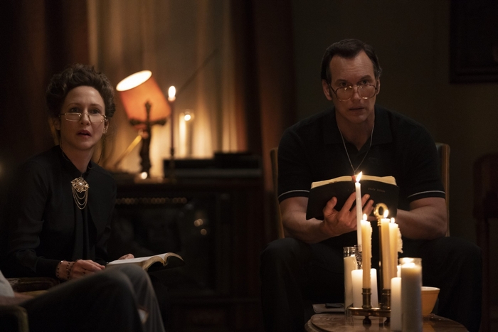 Ed and Lorraine Warren reading books by candlelight