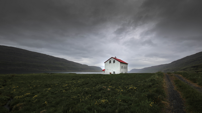 White house with red roof in Iceland landscape