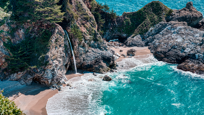 McWay Falls waterfall on a beach in California, USA
