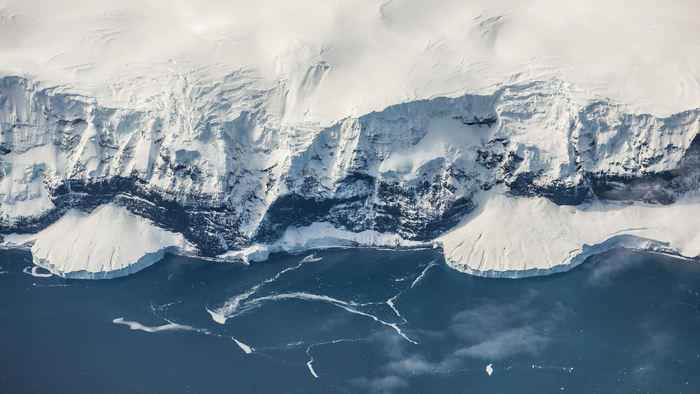 Aerial view of Antarctic ice cliffs and ocean