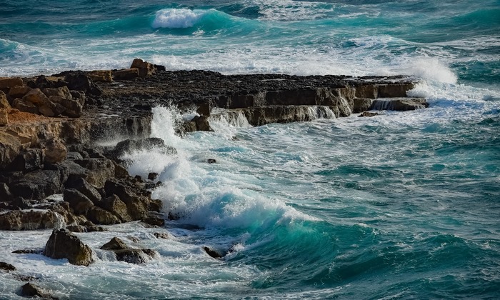 Waves crashing on rocky coastline