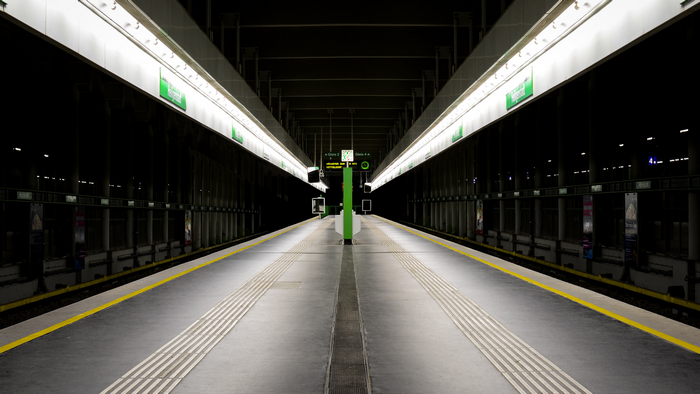 Empty subway platform in Vienna with green signs