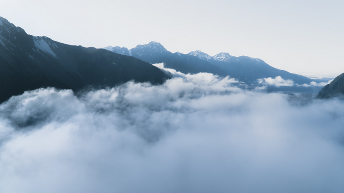 Mountains covered in snow and clouds in New Zealand