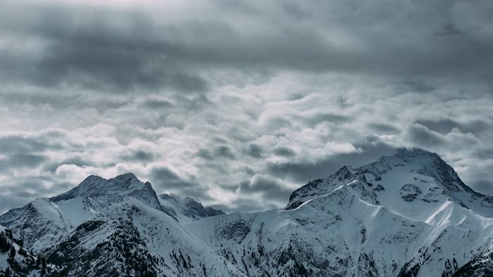 Snowy mountains under a cloudy sky