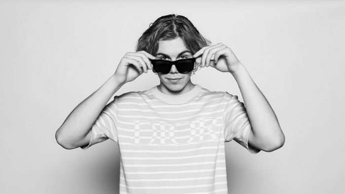 The Kid LAROI wearing sunglasses and a striped shirt