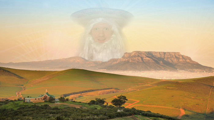 Giant man with beard and hat over mountains and farm