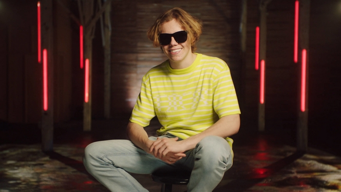 The Kid LAROI wearing sunglasses and a yellow shirt