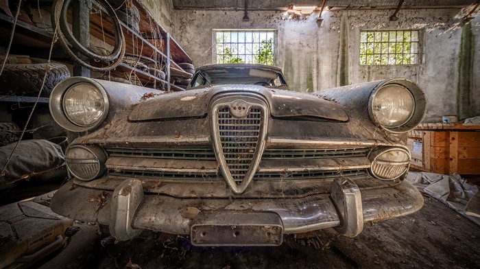 Abandoned Alfa Romeo car in a dusty garage