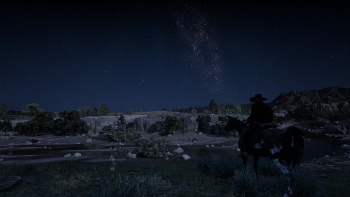 Man on horse under starry sky in Red Dead Redemption 2