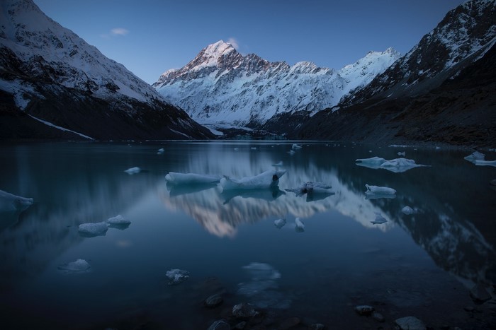 Mount Cook reflected in a glacial lake with icebergs, New Zealand