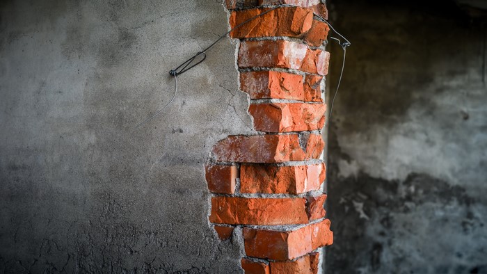 Damaged brick wall with concrete texture