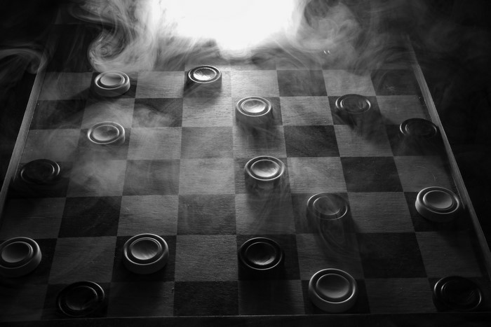 Checkerboard with checkers and smoke