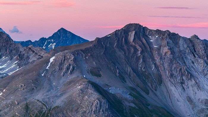 Mountains under a pink sky at sunset