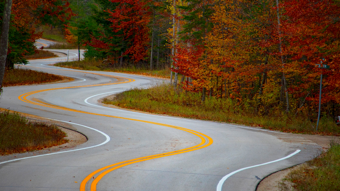 Winding road through autumn forest in Wisconsin
