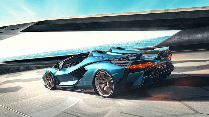 Blue Lamborghini Sian Roadster driving on a road