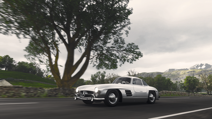 Silver Mercedes-Benz 300SL Gullwing driving on a road in Britain
