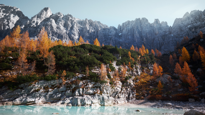 Autumn trees on a rocky mountainside overlooking a lake in Italy