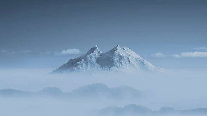 Snowy mountain peaks emerging from clouds