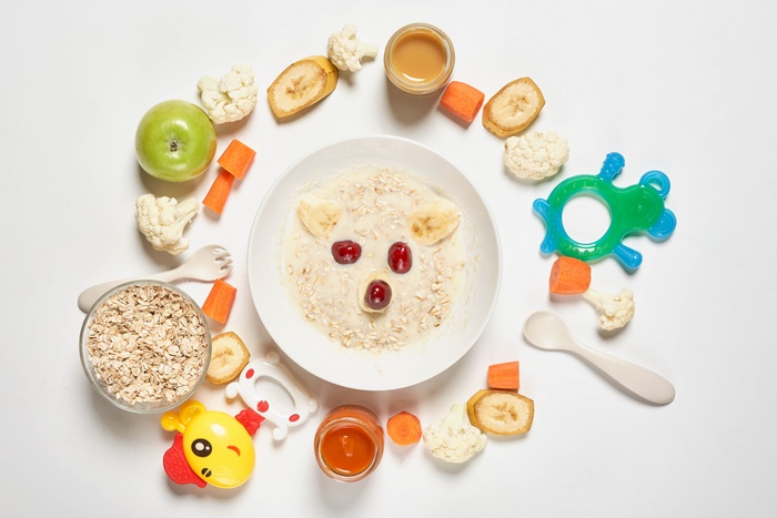 Bear-shaped oatmeal breakfast with fruits and baby food