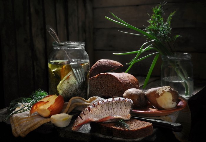 Still life with fish, bread, potatoes, and herbs