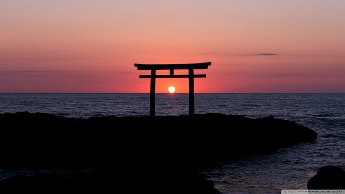 Torii gate at sunset over the sea