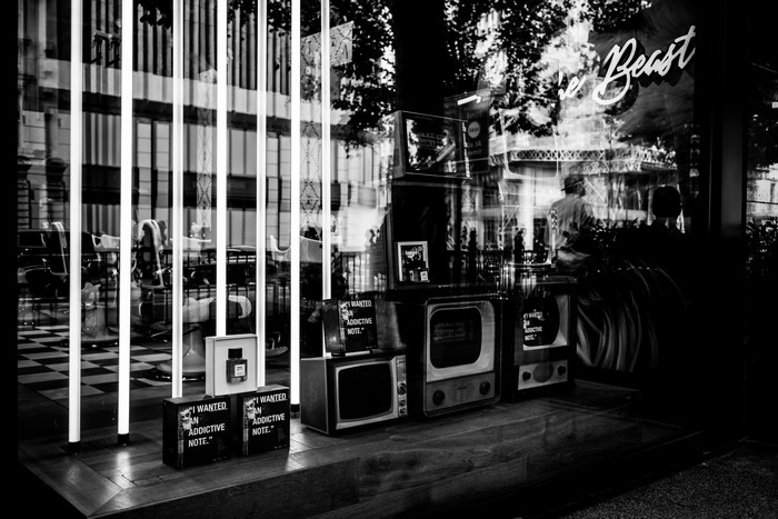 Monochrome shop window display with vintage TVs