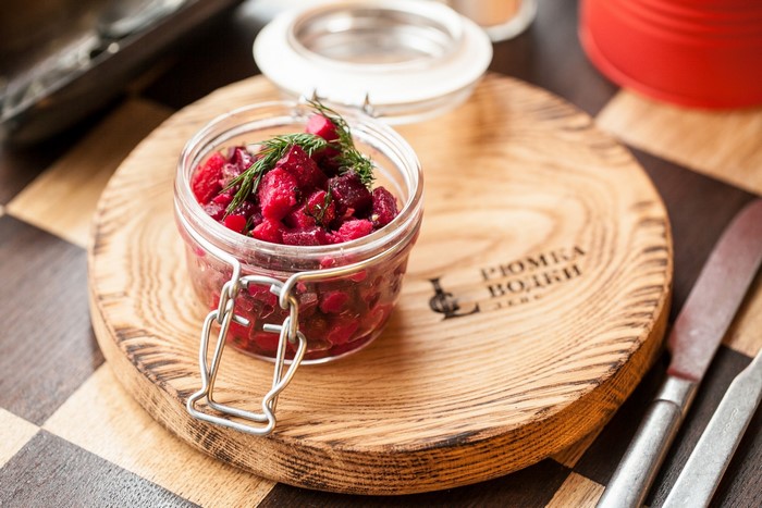 Beetroot salad in a jar on a wooden board